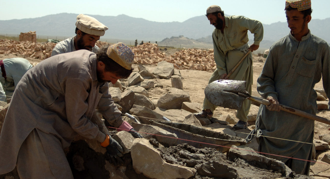 Afghan contractors work on building a wall that will surround the Afghani Border Police (ABP) compound in Dochina, Afghanistan, Sept. 2, 2005.  The construction is contracted by the U.S. Army for ABP and will result in brand new border police checkpoints.  (U.S Army photo by Pfc. Michael Zuk)  (Released)