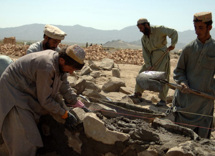 Afghan contractors work on building a wall that will surround the Afghani Border Police (ABP) compound in Dochina, Afghanistan, Sept. 2, 2005.  The construction is contracted by the U.S. Army for ABP and will result in brand new border police checkpoints.  (U.S Army photo by Pfc. Michael Zuk)  (Released)